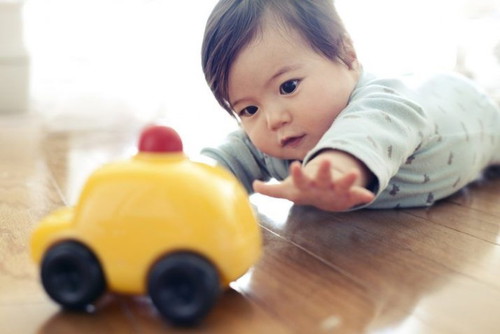 When could your baby start to hold onto objects?
