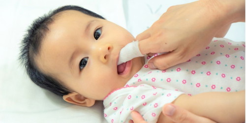 How do you clean milk from your baby's tongue?