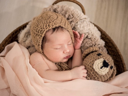 What is the recommended sleeping position for newborns?