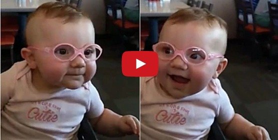 Baby wears glasses for the first time and can't stop smiling!