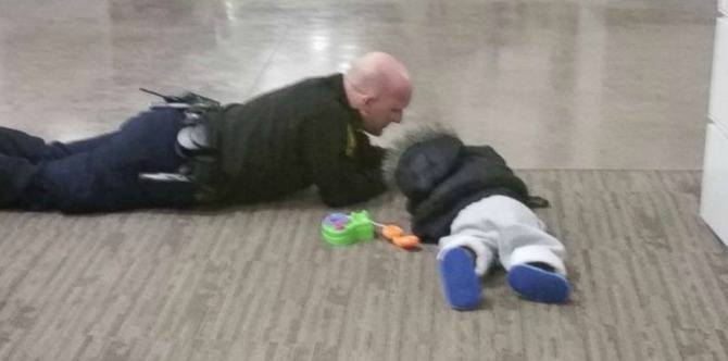 Find out why this photo of a police officer playing with a toddler goes viral