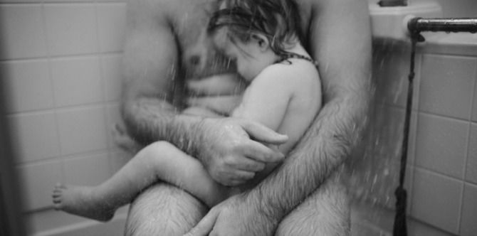 Powerful image of father comforting sick son in the shower goes viral