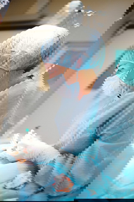 female doctor in blue scrubs - infected c section wound
