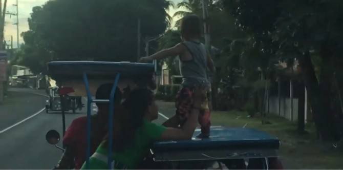 Watch: Mother caught on video putting her son on top of a moving tricycle