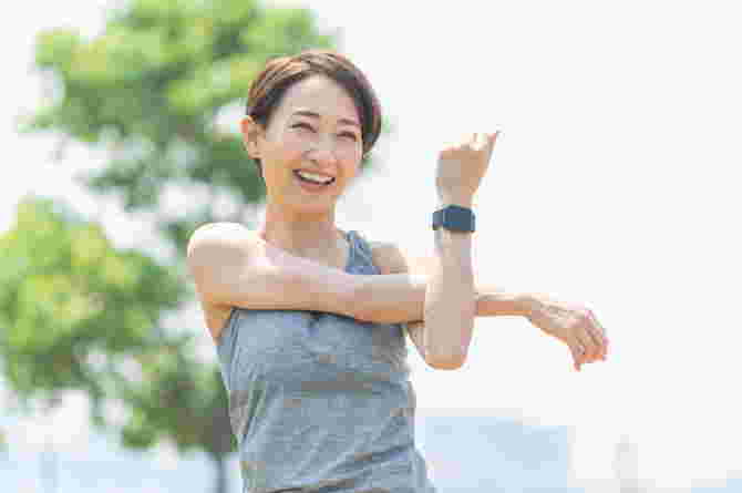 sports after birth - asian woman stretching