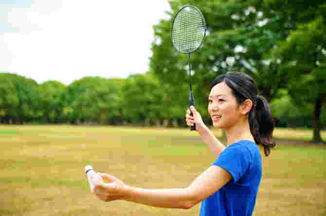 sports after birth - asian woman playing badminton