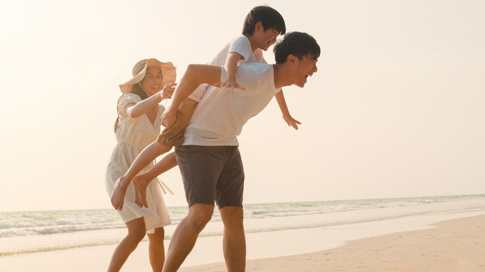 family having fun at the beach