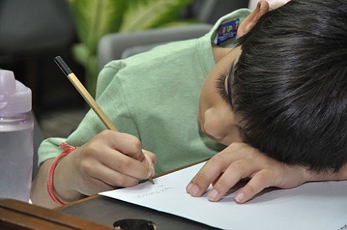 Child learning Tamil in Singapore