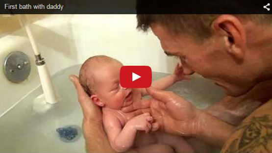 Super cute! Dad goes in for a bath with his newborn baby