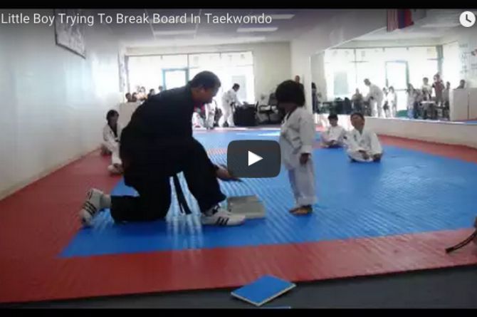 Watch this adorable little boy try to break a board!
