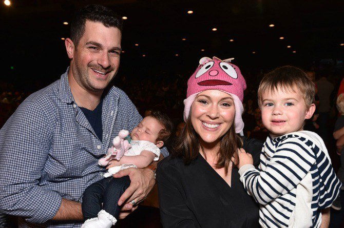 Alyssa Milano as Wonder Woman, breastfeeding her baby, in throwback Halloween picture