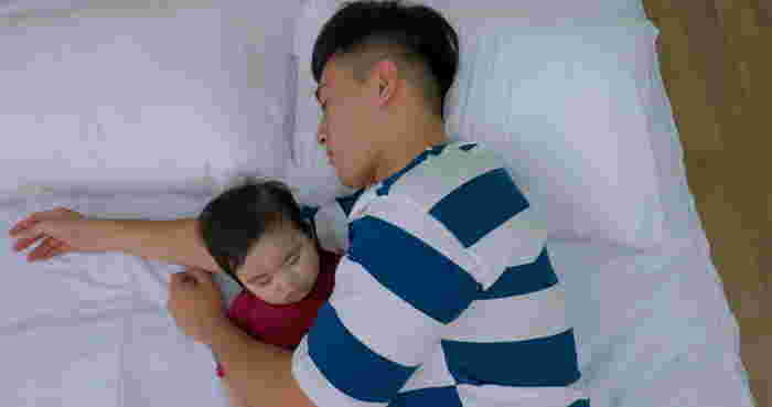 dad sleeping beside baby