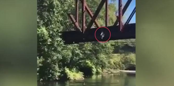 This video shows a mother cheering as her child is thrown off a bridge