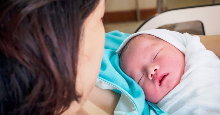 Mother with her newborn baby in hospital in Singapore