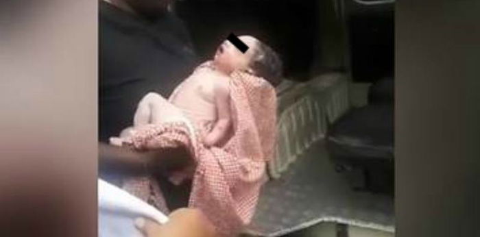 Unwanted newborn flung from building by his mother, clings to life