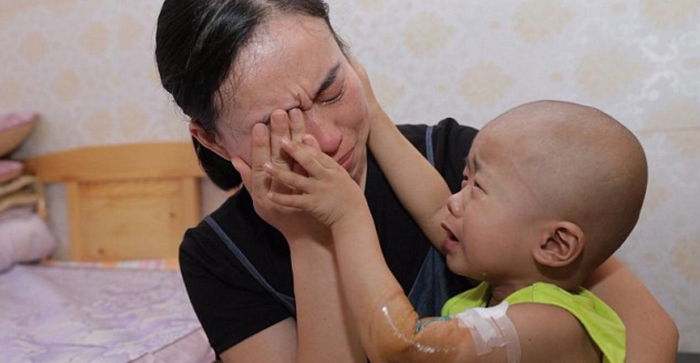 Little boy with cancer comforts mum who cannot afford his treatment