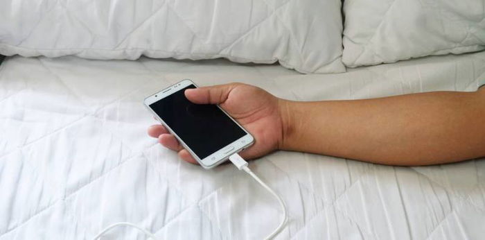 Phone left charging overnight explodes, burning woman