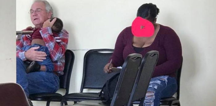 Heartwarming photo of stranger comforting baby gives us all hope