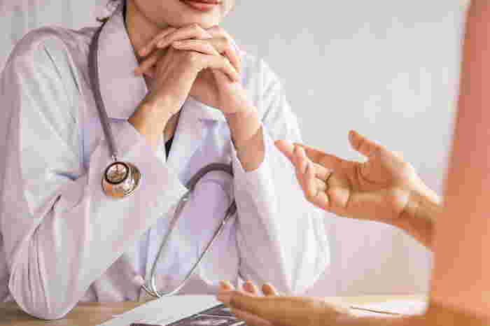 doctor listening to her patient