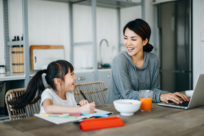 child and mum working side by side