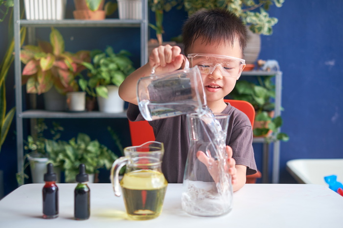 boy doing an experiment at home