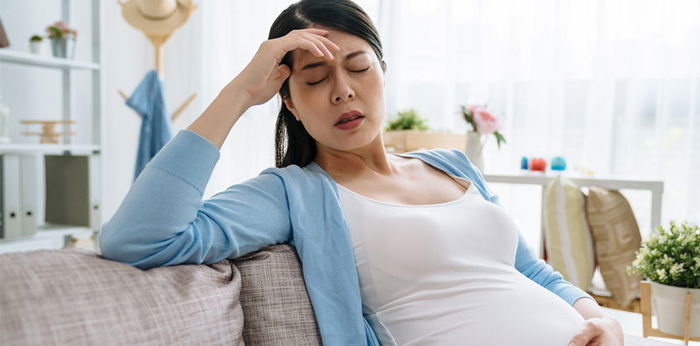 Pregnant woman has pain in the middle of her stomach. What is the symptom? Should I see a doctor?